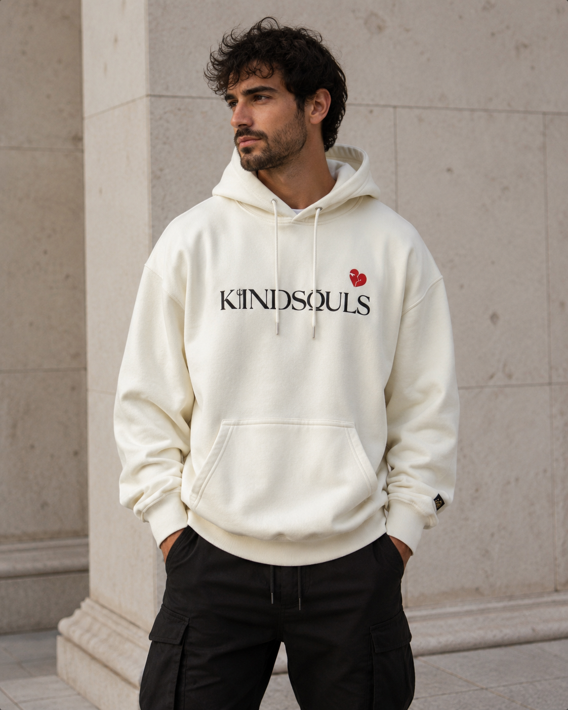 Close front view of a model wearing the off-white KiiNDSOULS Broken Heart heavyweight hoodie