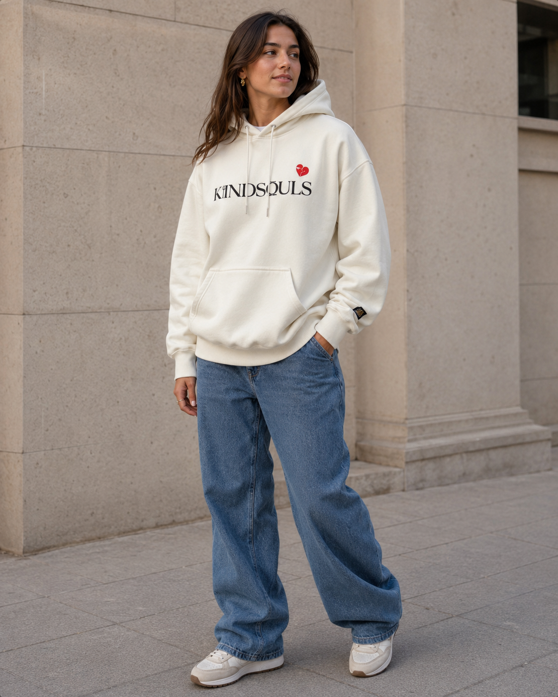 Woman wearing the off-white KiiNDSOULS Broken Heart heavyweight hoodie in a relaxed front fit